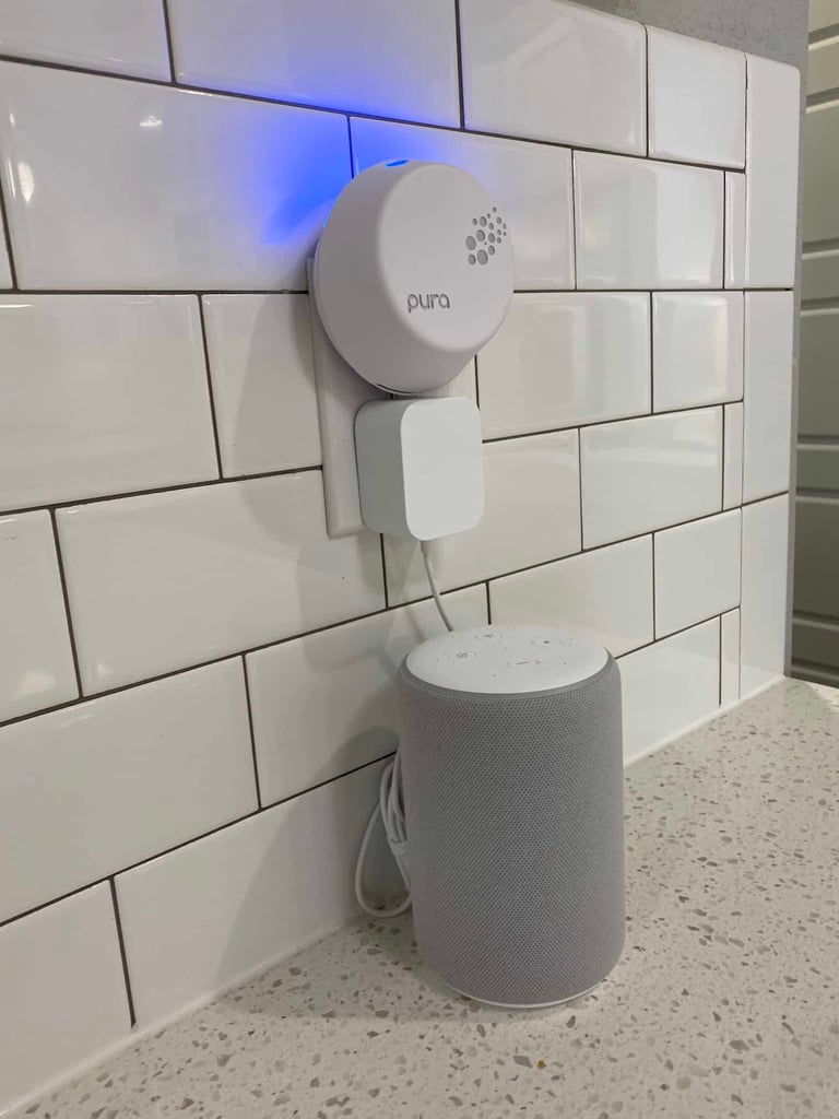 a white speaker on a white tile wall