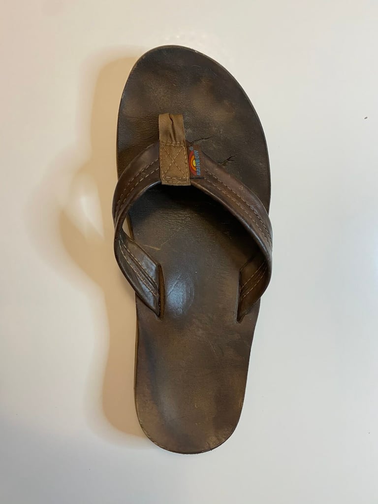 a brown sandal with a broken edge