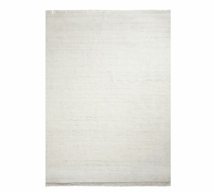 a white rug with fringe