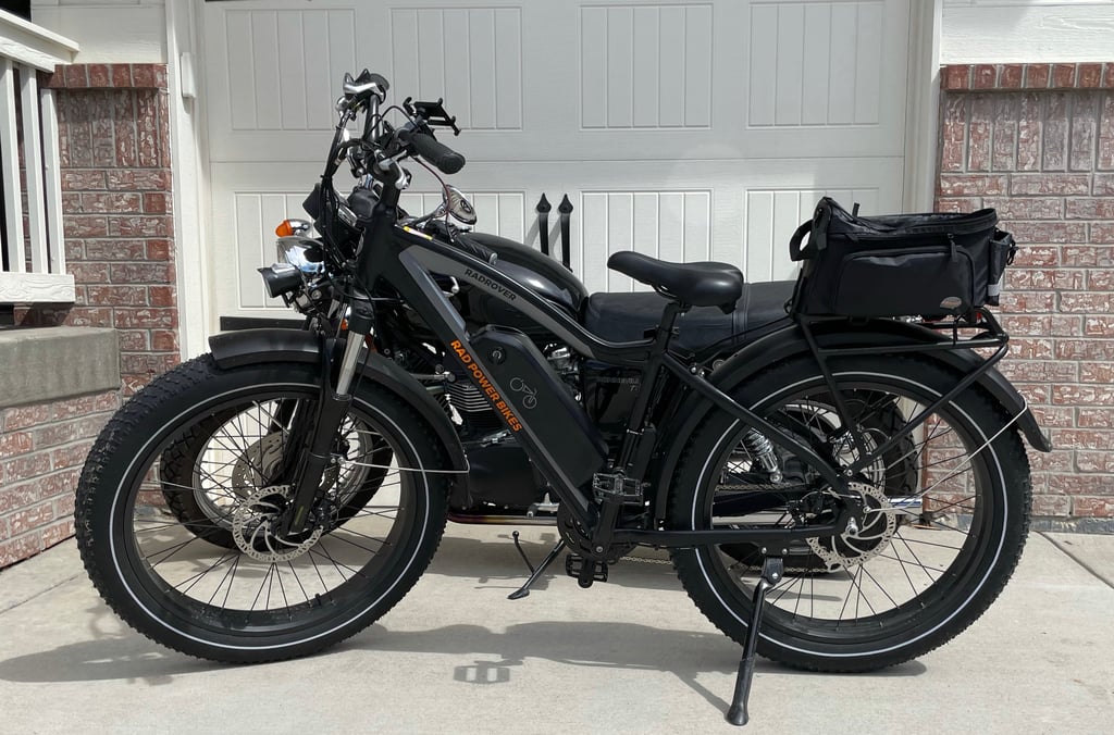 the radrover5 (in front) without the urider kids seat and a triumph motorcycle in the back