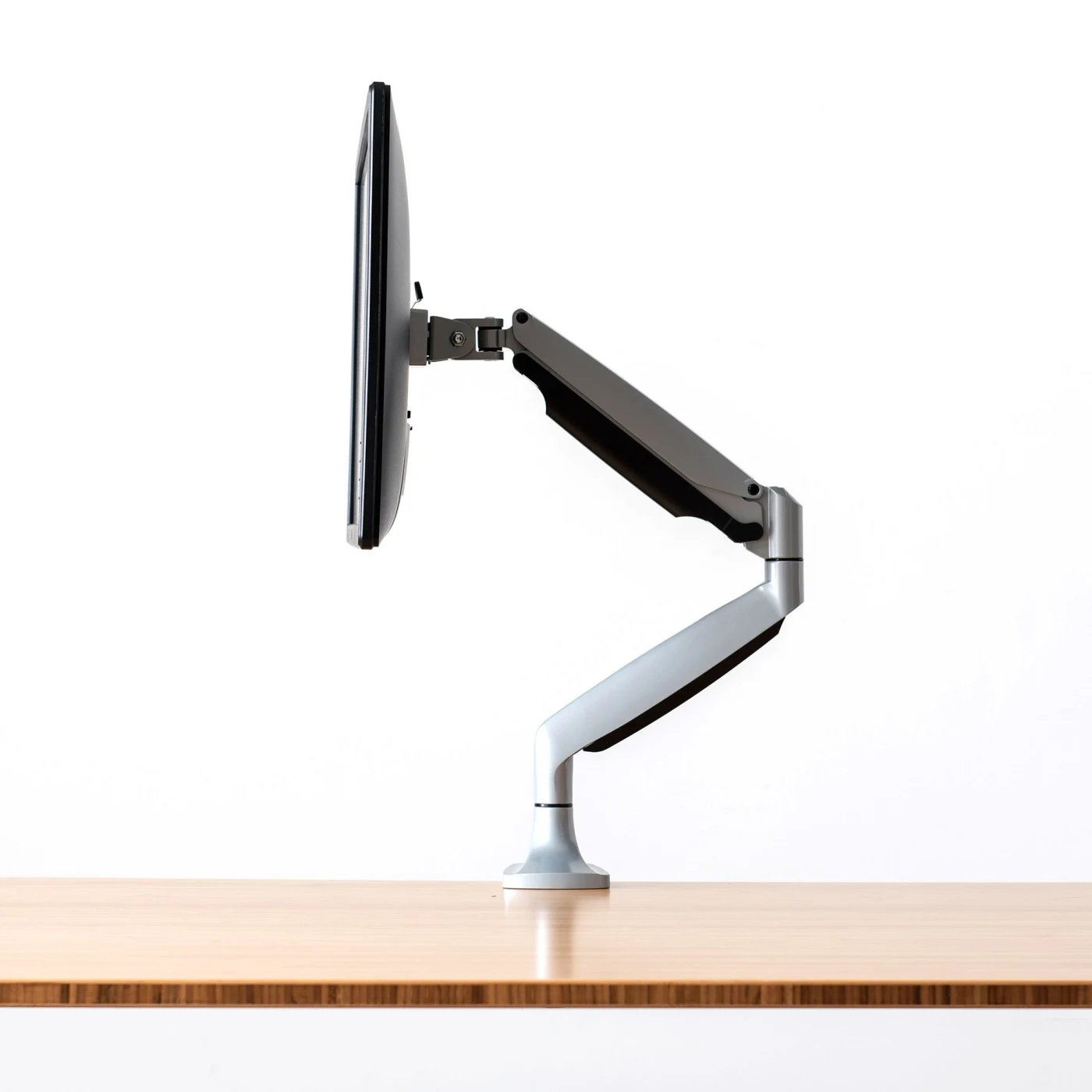 fully jarvis monitor arm mounted to jarvis desk with monitor silver side view c v1