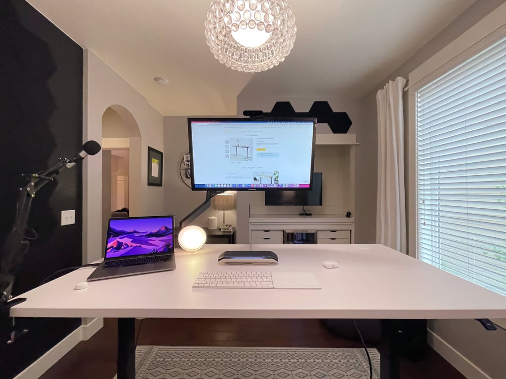 a desk with a laptop and a keyboard