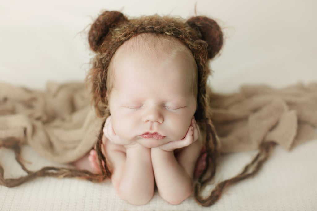a baby sleeping with a knitted hat