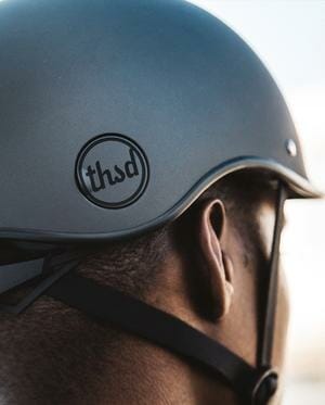the poplock looks like a logo, but is also a way to secure your helmet when it’s not on your head