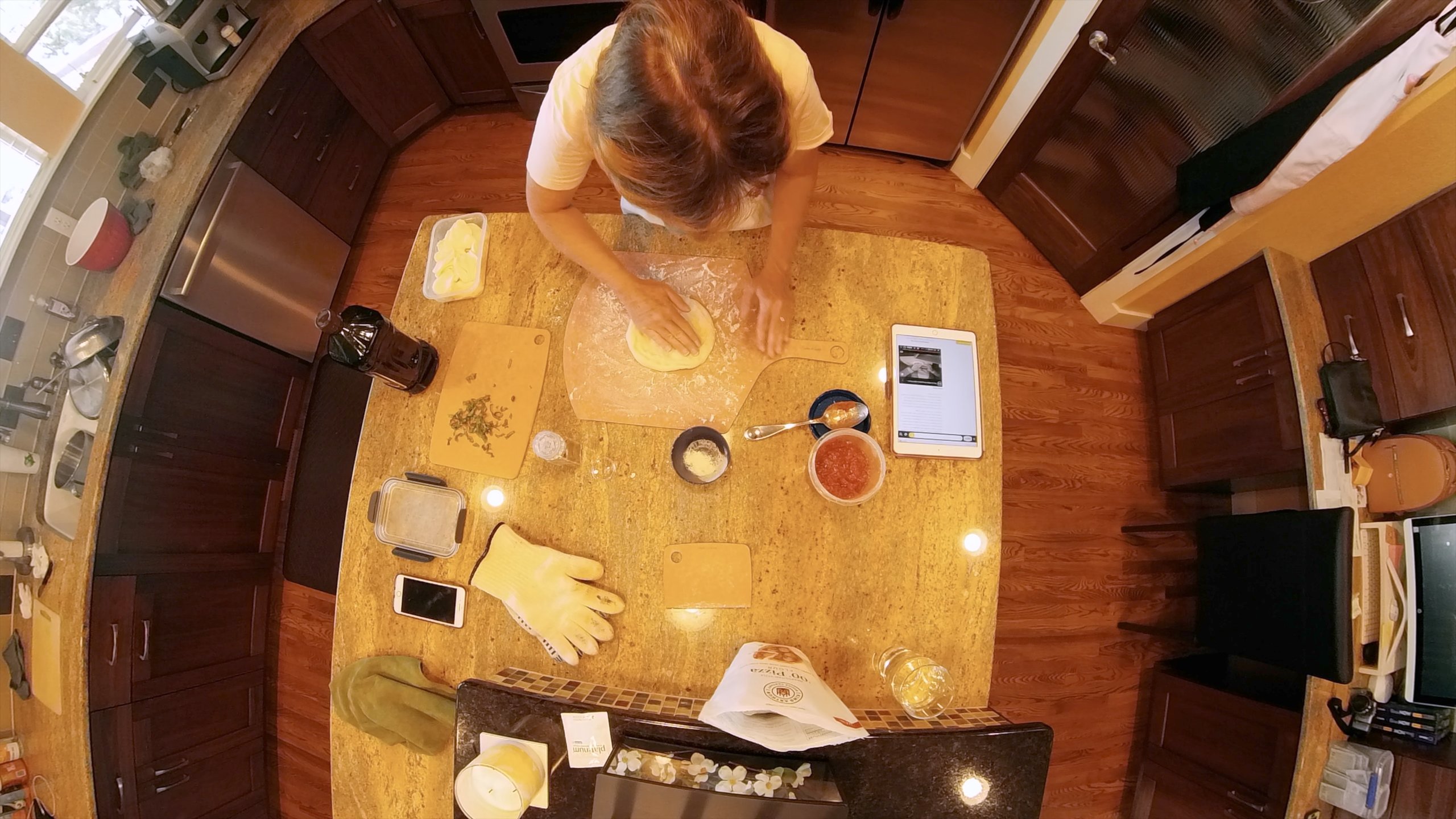 a woman making pizza on a table