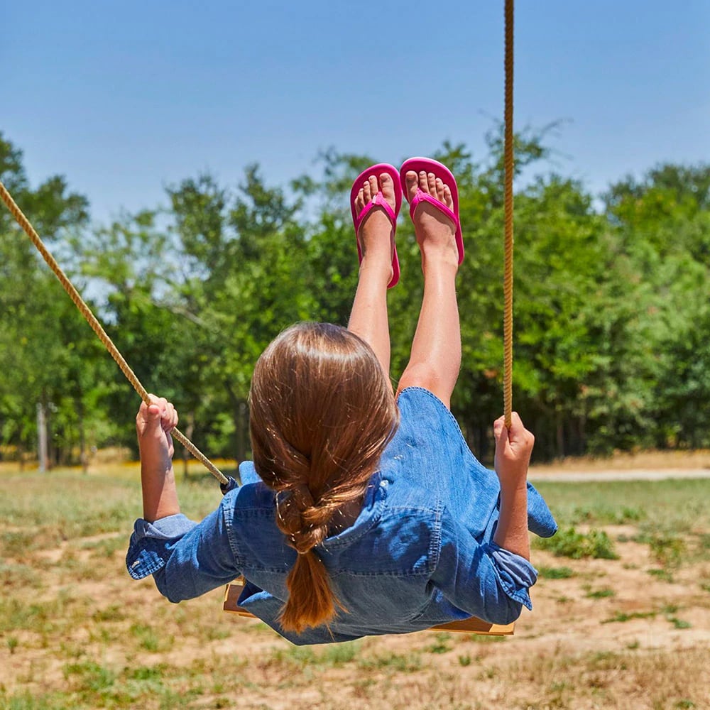 a girl swinging on a swing