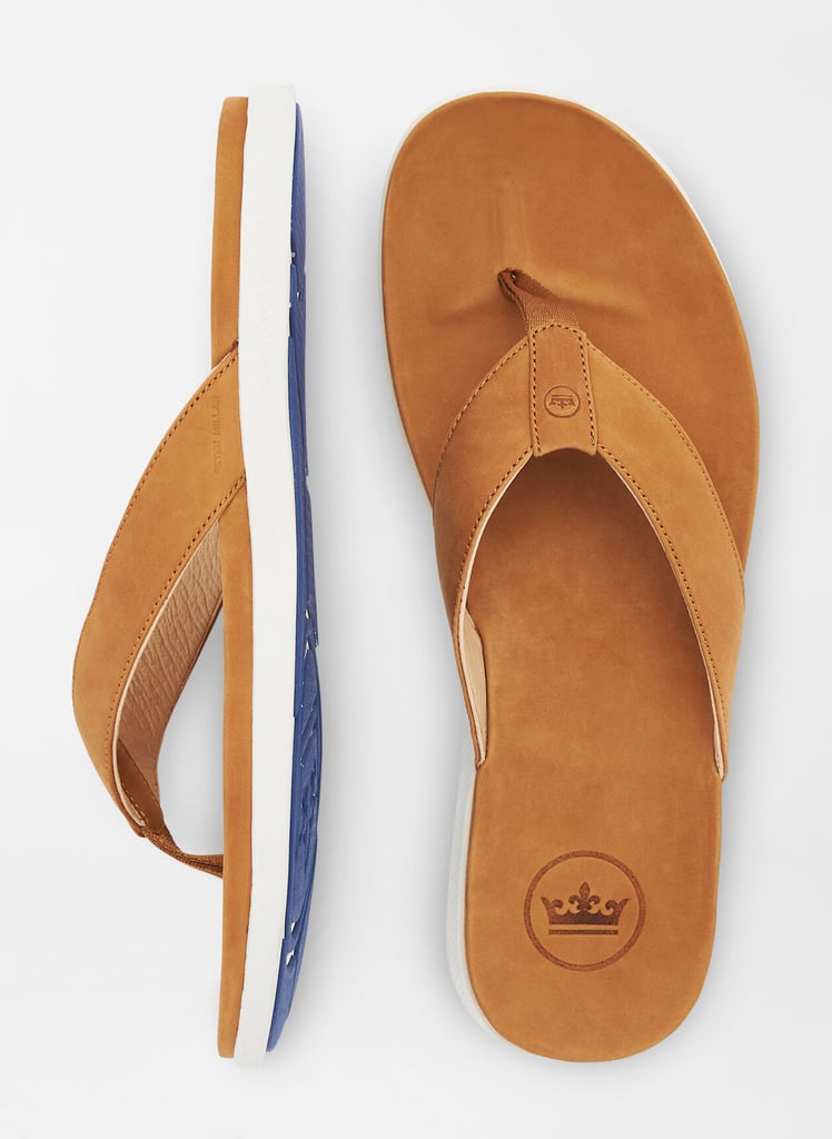 a brown sandal with blue sole