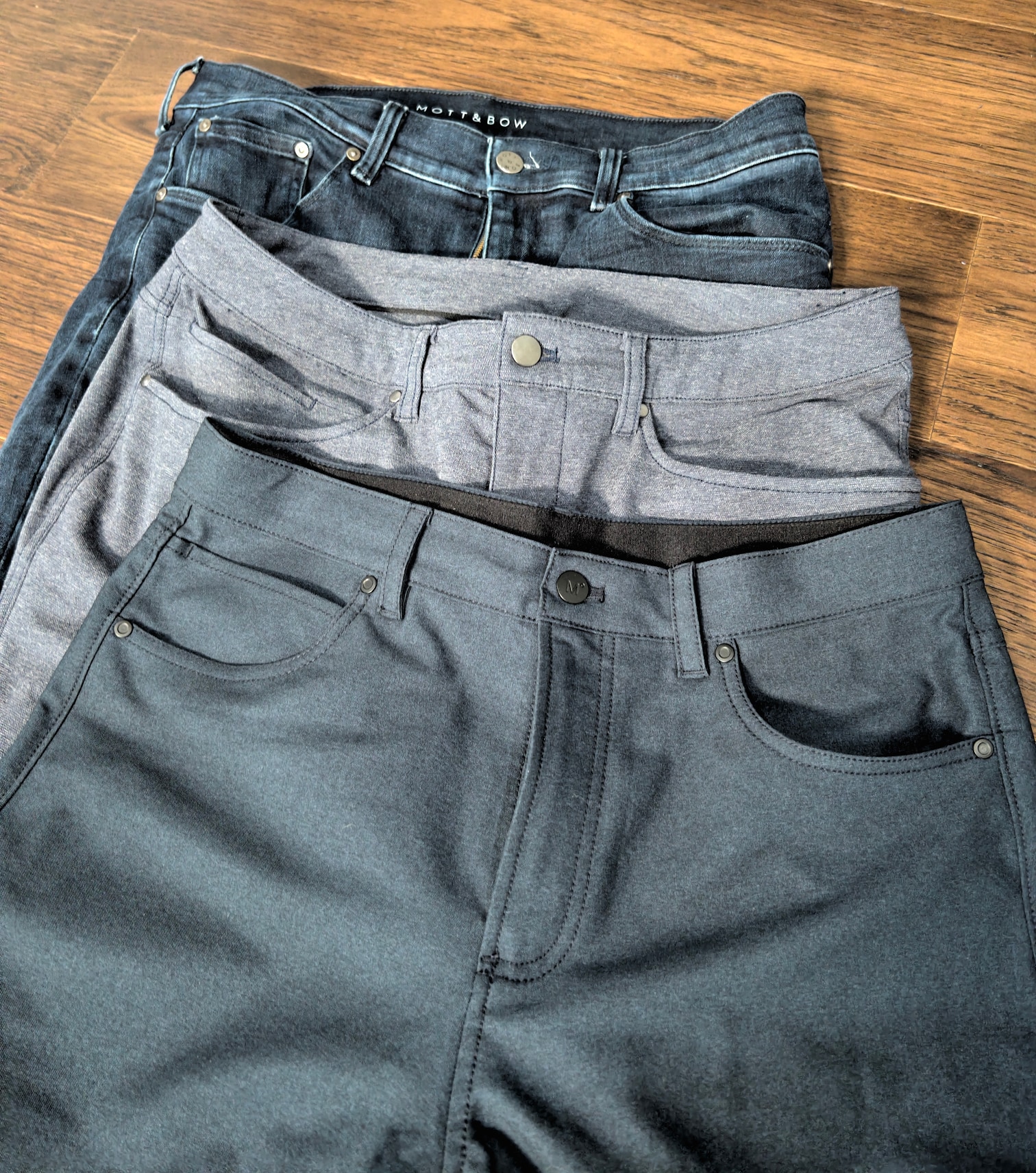 kinetic twill pants (bottom of image, top of pile), lululemon tech canvas (middle), mott & bow jeans (top of image, bottom of pile)