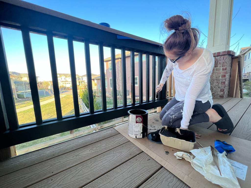 a woman painting a deck