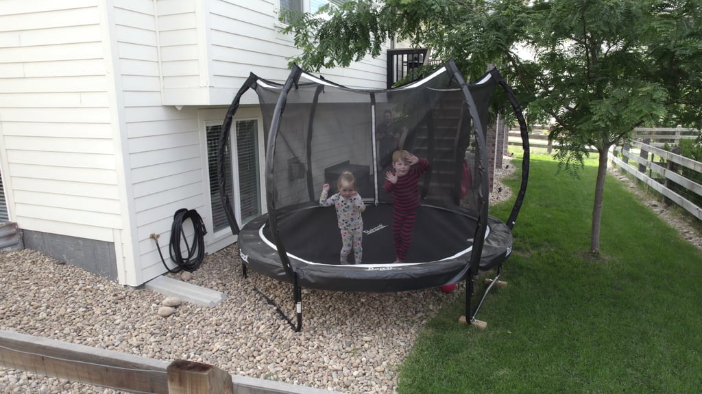 two children jumping on a trampoline