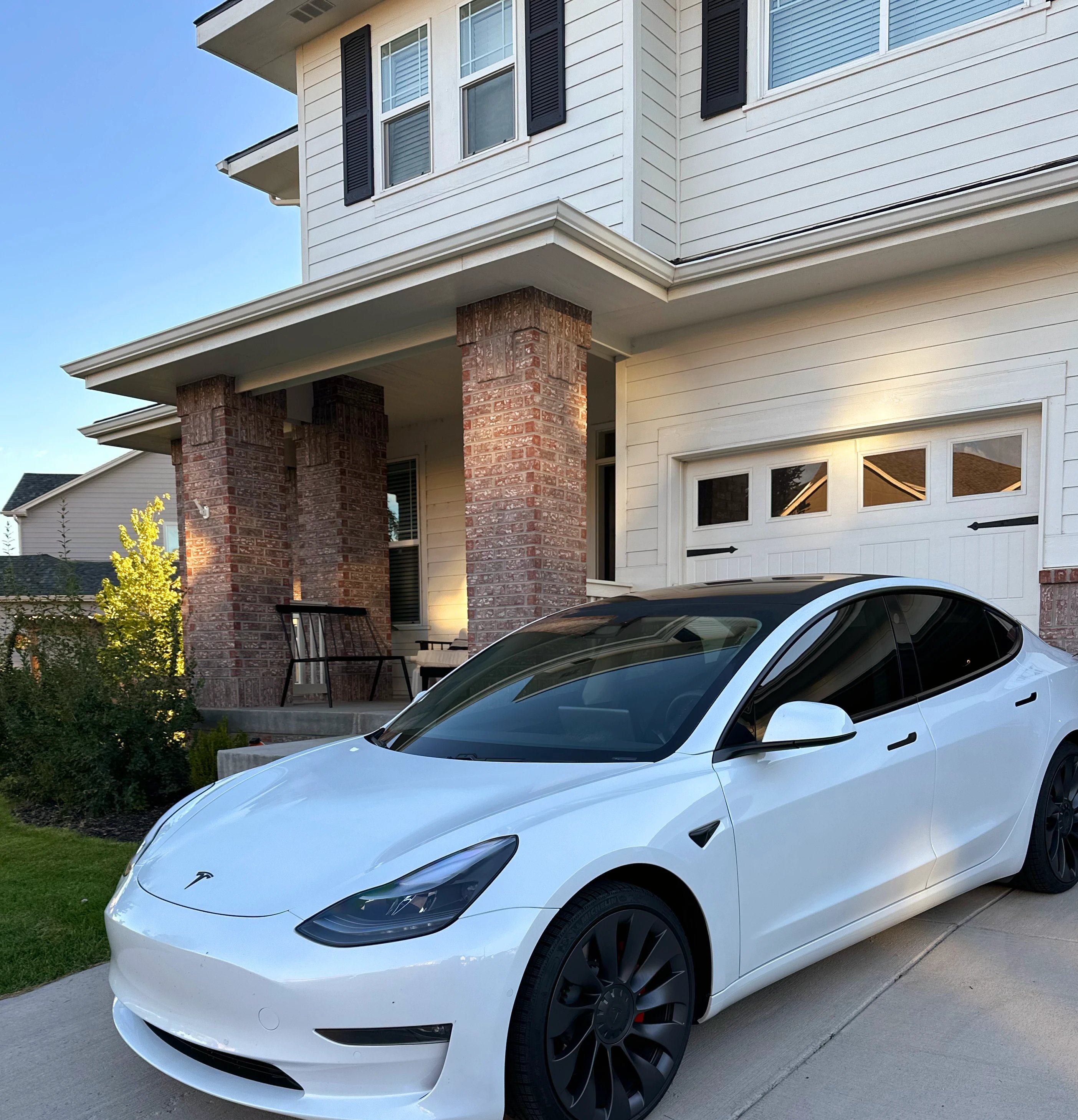 a white car parked in front of a house