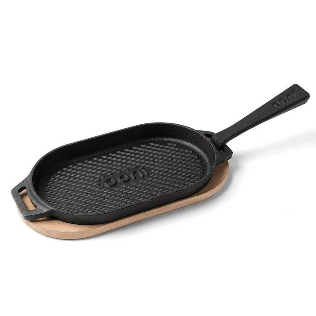 a black cast iron pan with a wooden tray